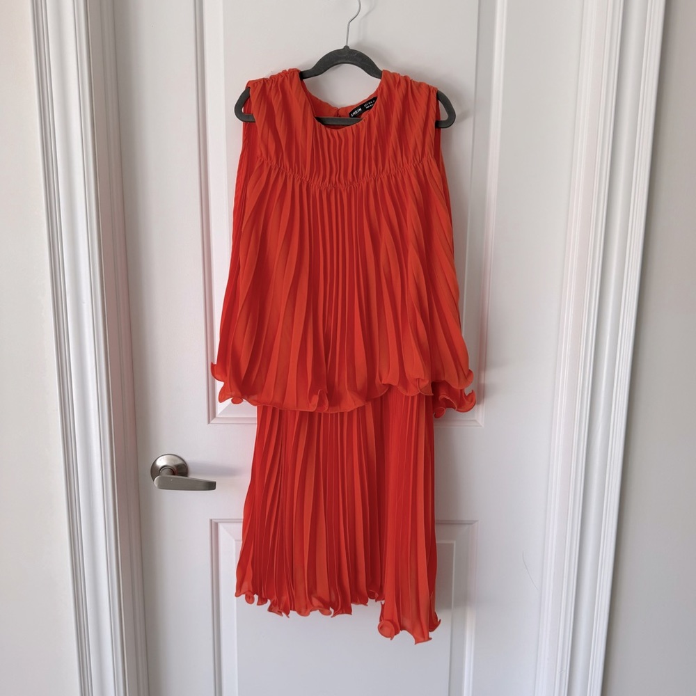 Cape style pleated dress with draping back & front. Knee length both fun & sexy!